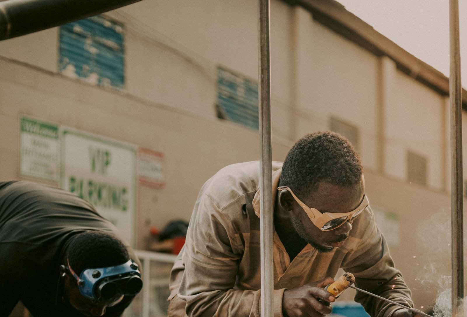 Industrial workers welding a metal structure at a South African workshop