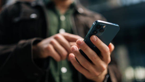 Person checking their SASSA SRD grant status on a smartphone